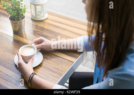 Woman having latte in cafe Stock Photo