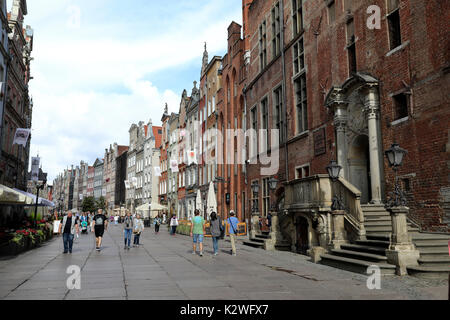 Pedestrians wander along Dluga Street, the main thoroughfare in the Old Town of Gdansk, Poland, on 20 August 2017. The city museum is on the right. Stock Photo