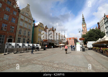 Pedestrians walk through Dluga Targ, the square that forms part of Dluga Street in the Old Town of Gdansk, Poland, on 20 August 2017. Stock Photo
