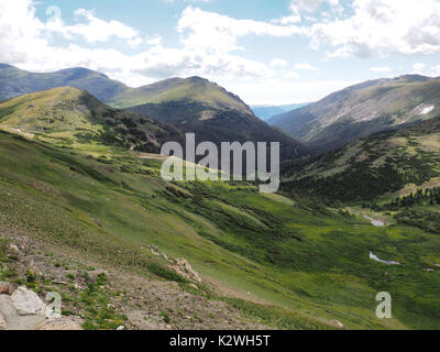 Summer in the tundra in Rocky Mountains National Park in Colorado.White puffy clouds cast shadows on the land below. Stock Photo