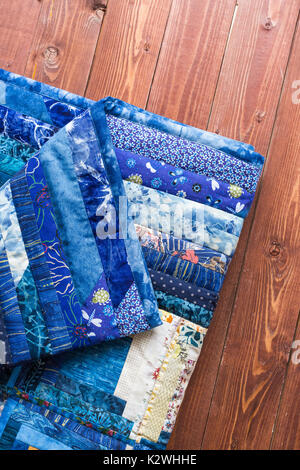 rest, coiziness, patchwork concept. face and underside of gently maded by hands blue-colored badcover contained many different textile scrapes and patterns Stock Photo