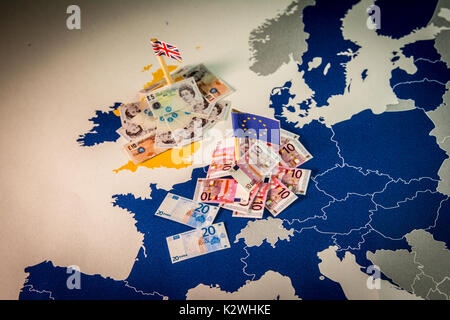 EU and UK flags,euro and pound bills on a european map with EU members in blue.Suitable for a concept of BREXIT,pound against euro,London or Frankfurt Stock Photo