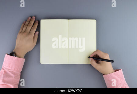 Hands writing in the note book. Flat lay style. Stock Photo