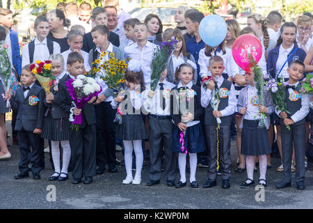 Adygea, Russia - September 1, 2017: Children enrolled in the first grade at school with teachers and parents at the inauguration of the school year in Stock Photo