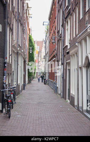 Holland, North, Amsterdam, Bicycle parked in typical narrow cobbled street. Stock Photo