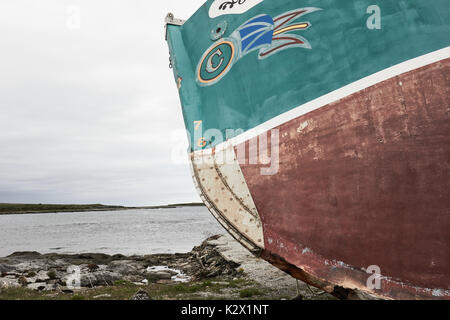 Newfoundland and Labrador flag painted on a rusting fishing trawler, Great Northern Peninsula, Newfoundland, Canada Stock Photo