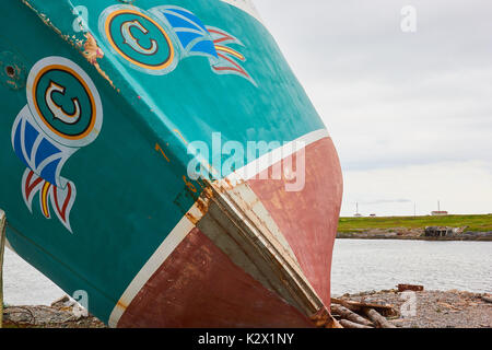 Newfoundland and Labrador flag painted on a rusting fishing trawler, Great Northern Peninsula, Newfoundland, Canada Stock Photo