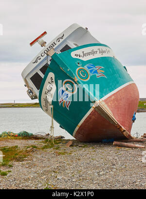 Newfoundland and Labrador flag painted on a rusting fishing trawler, Great Northern Peninsula, Newfoundland, Canada Stock Photo