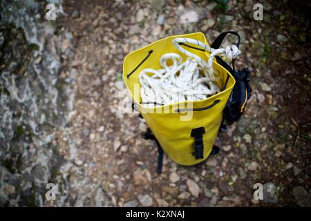 Climbing rope inside a yellow backpack. Stock Photo