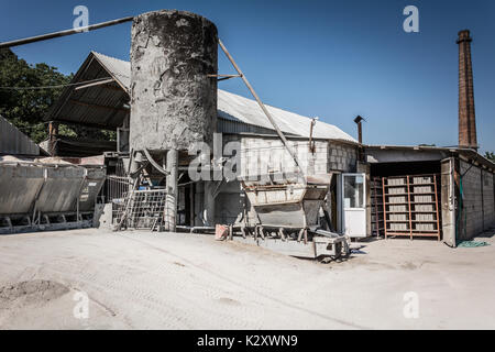 Cement factory. Equipment for the production of cement blocks in a small cement factory. Stock Photo
