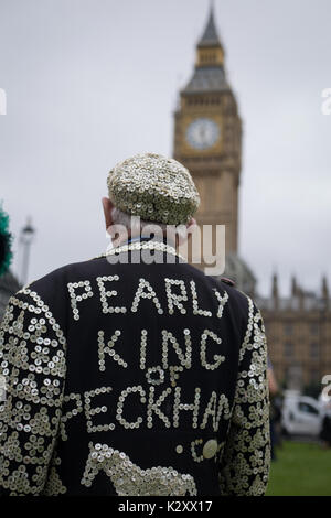 Pearly King, Queen and Prince of Peckham, in their Pearly Kings clothes, outside Houses of Parliament and Big Ben, London, England, UK. Stock Photo