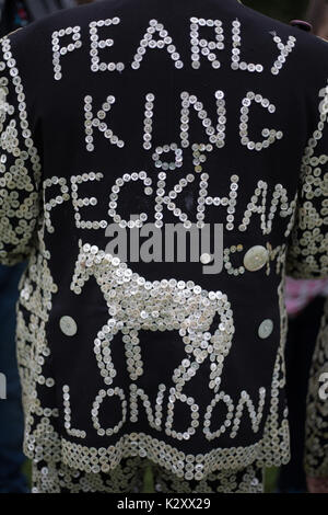 Pearly King, Queen and Prince of Peckham, in their Pearly Kings clothes, outside Houses of Parliament and Big Ben, London, England, UK. Stock Photo