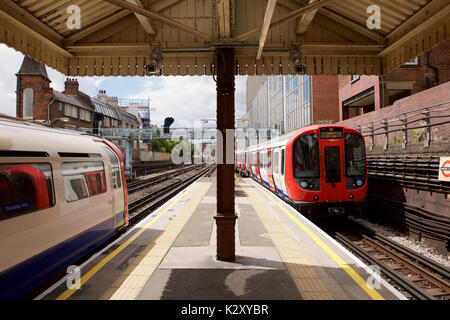 Underground train at Barons Court Underground station in London Stock Photo