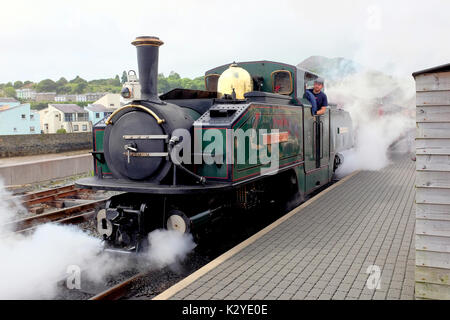 Porthmadog, Wales, UK. August 03, 2017. A Festiniog railway engine about to leave the station blowing off steam before departure at Porthmadog in Wale Stock Photo