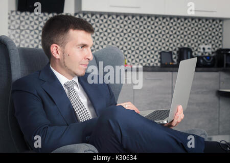 Businessman working in home with computer in the morning Stock Photo