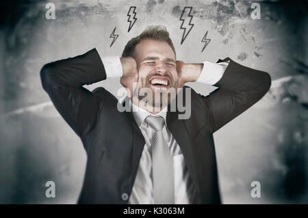 Employee hate his work and, screaming and covering his ears. angry businessman stress work job furious business overload concept Stock Photo