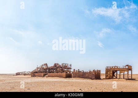 The rusted remains of an abandoned oil drilling rig between Henties Bay and Torra Bay in the Skeleton Coast area of Namibia Stock Photo