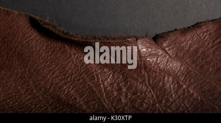 Isolated vintage weathered old brown leather on a dark background Stock Photo