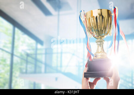 Businessman holding award trophy for show their victory. Stock Photo