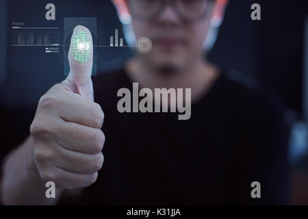 Young businessman scan fingerprint for identity analytics , concept of the internet and future immersive technology for business security . Stock Photo