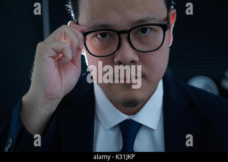 Portrait of serious young asian businessman looking at camera. Stock Photo