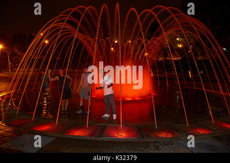 Tourists in Walk-in Dome Fountain at the Magic Water Circuit (world's largest fountain complex), Park of the Reserve, Lima, Peru, South America Stock Photo