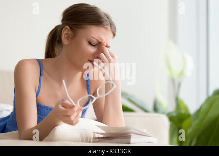 Lady feeling headache or dizziness while reading Stock Photo