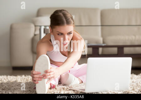 Flexible lady doing physical exercises at home Stock Photo