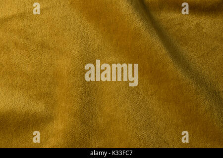 Golden angora goat velours fabric resembling velvet, mixed with natural silk threads. mohair textile. cashmere, velvet suede and chamois effect. for u Stock Photo