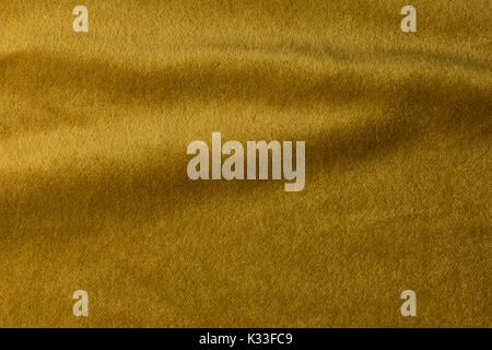 Golden angora goat velours fabric resembling velvet, mixed with natural silk threads. mohair textile. cashmere, velvet suede and chamois effect. for u Stock Photo