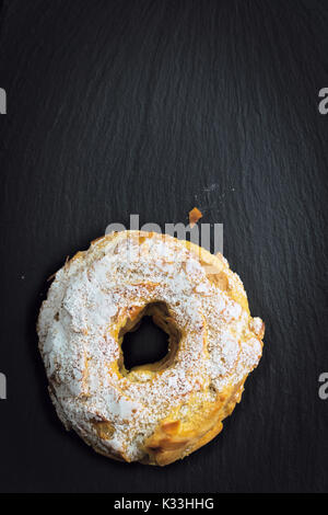Paris Brest Famous French dessert sweet  round pastry in the form of a wheel on black slate plate with copy space Stock Photo