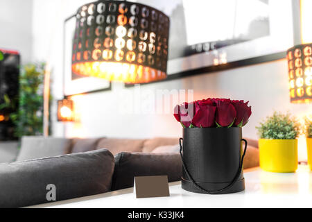 Roses in black box standing on the white table Stock Photo
