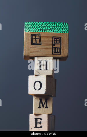 House model with home word made from wooden blocks. Stock Photo