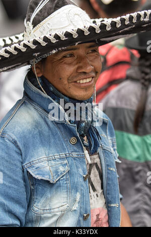 June 24, 2017 Cotacachi, Ecuador: man using conch shell to make noise at the Inti Raymi parade Stock Photo