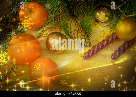 On a wooden table beautifully set decorations and gifts for Christmas, the New year pine branches, cones, shiny balls, candles, confetti. Stock Photo