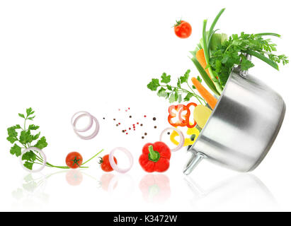 Fresh vegetables coming out from a stainless steel casserole pot Stock Photo