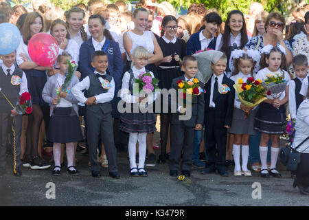 Adygea, Russia - September 1, 2017: children with bouquets of flowers enrolled in the first class at school at the inauguration of the school year in  Stock Photo