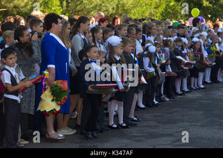 Adygea, Russia - September 1, 2017: children enrolled in the first class with gifts in the hands of teachers and high school students on the school's  Stock Photo