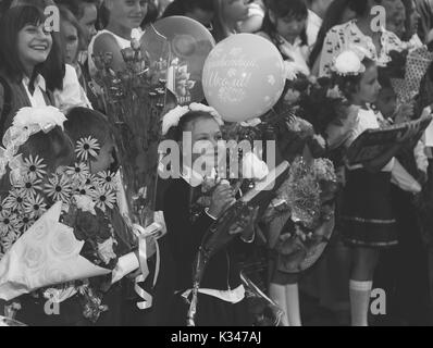 Adygea, Russia - September 1, 2017: happy children enrolled in the first grade with gifts in hand with teachers and pupils at the school the solemn ru Stock Photo