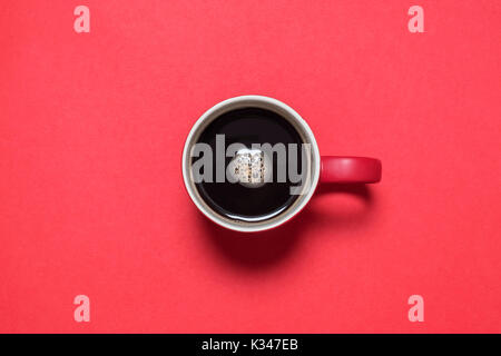 Black Coffee in Red Mug Isolated on Bright Red Background Stock Photo
