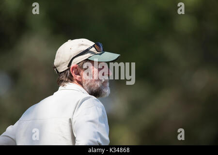 Bearded man wearing a cap looking into the distance Stock Photo