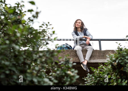 Portrait of a positive teenage girl with braided plaits. Stock Photo