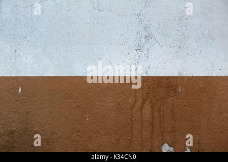 Painted concrete wall with cracks, stains and peeling paint. Stock Photo