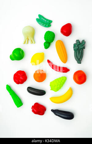 Group of vegetable and fruit plastic toys for children in isolated white background. Stock Photo