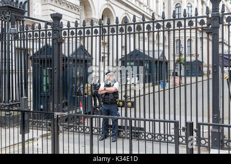 LONDON, ENGLAND - JUNE 08, 2017: Police officers guards the gate of Downing Street 10, residence of the prime minister, in London United Kingdom Stock Photo