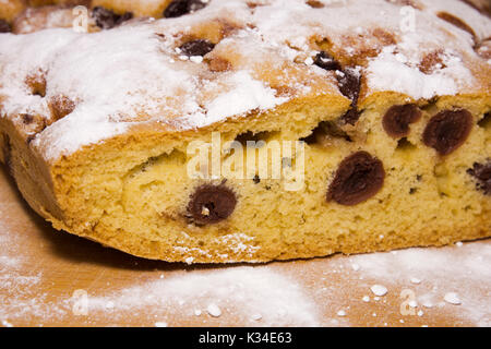 Homemade sweet Hungarian bread with prunes with sugar on a wooden surface Stock Photo