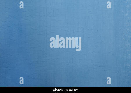 Vintage wall of light blue color in plaster cracks. Stock Photo