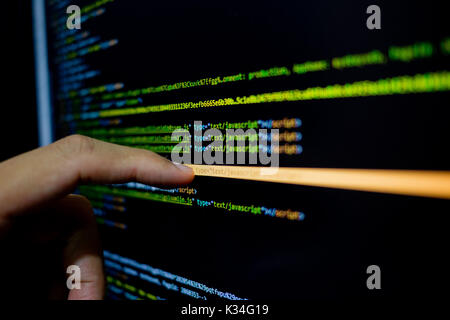 finger touch screen on monitor  Java code. Programming language screen Stock Photo