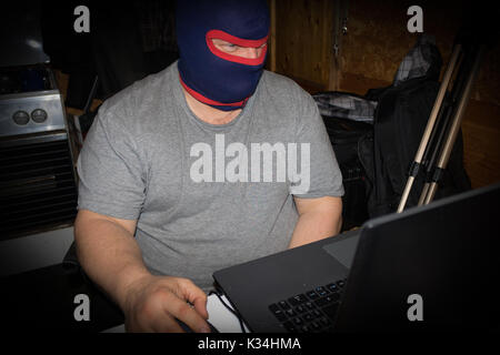 Terrorist working on his computer. Concept about international crisis, war, terrorism ,terrorist and bandit Stock Photo