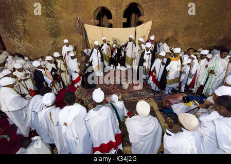 Priests chanting prayers in the courtyard of Bet Medhane Alem church, during the prayers on Ethiopian Easter Saturday, Lalibela, Ethiopia Stock Photo